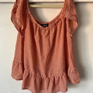It’s a girl medium blouse. It’s in the orange family like a peach or coral.